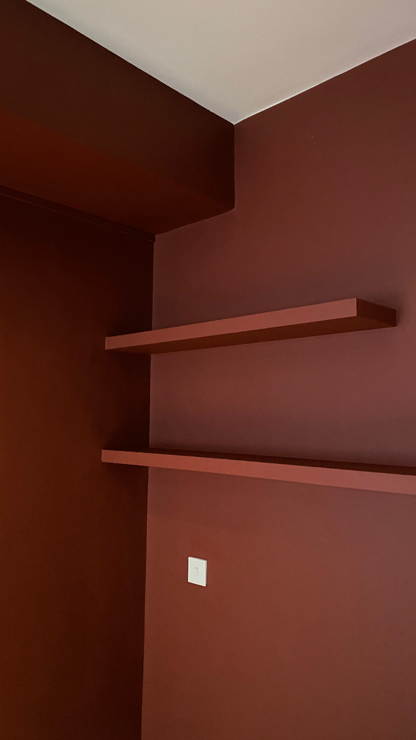 Red velvet bed frame styled in a bedroom