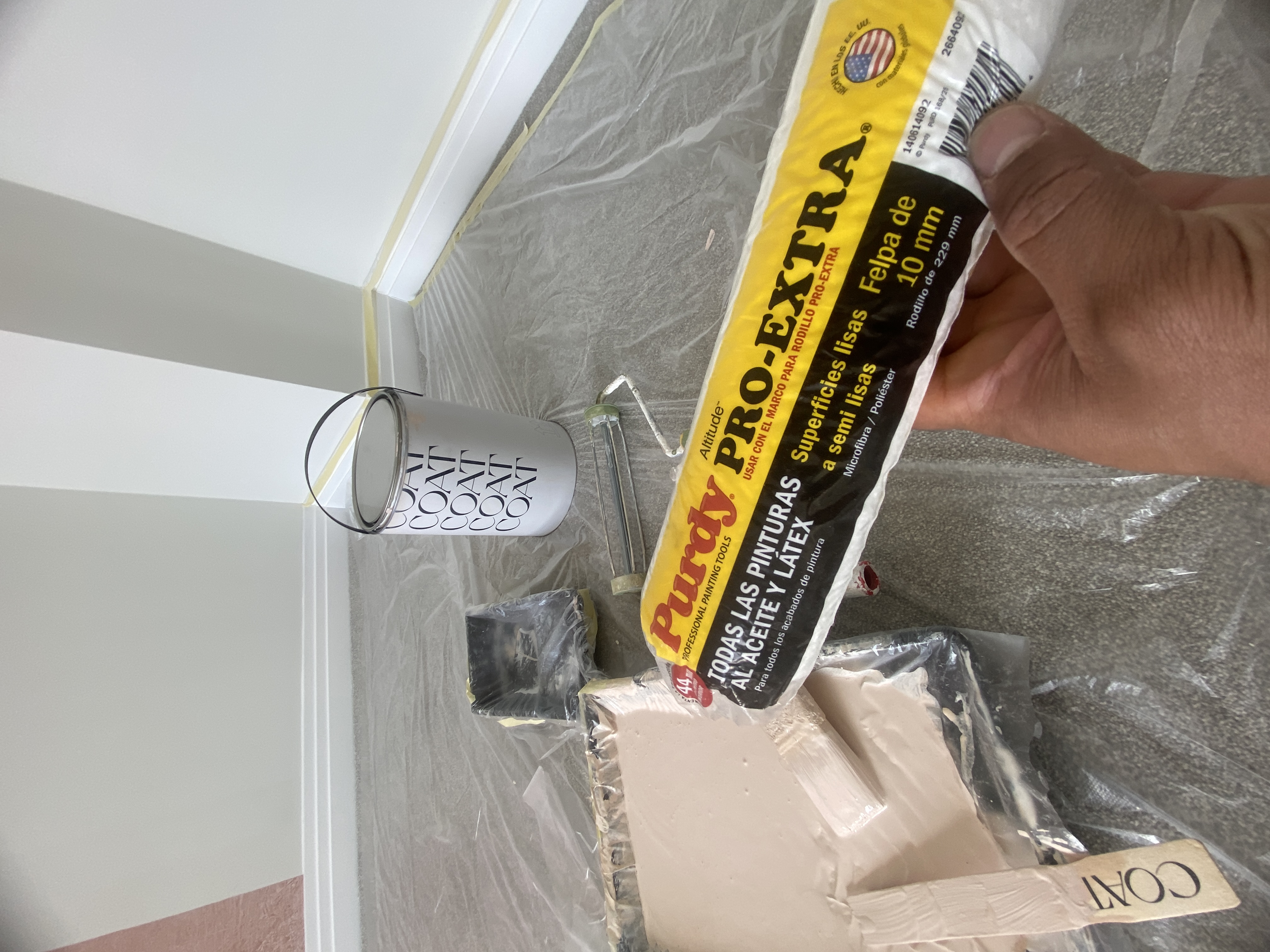 Freshly applied pink COAT emulsion around a bedroom door frame and white skirting