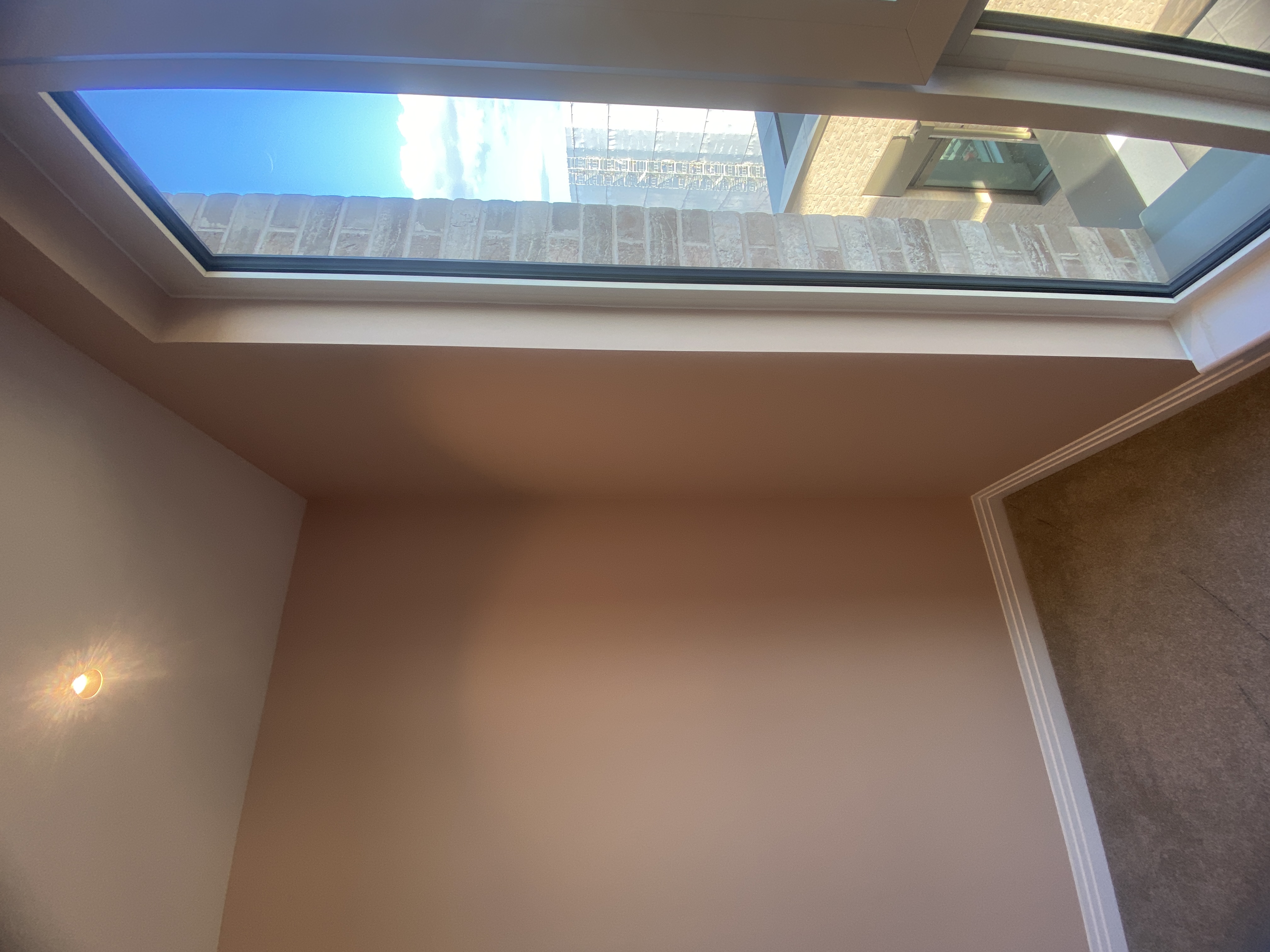 Finished COAT painted bedroom corner showing an even pink finish around the window